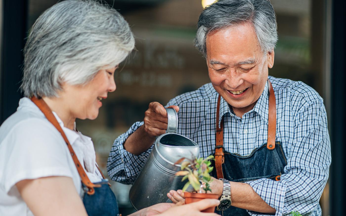 couple watering a plant